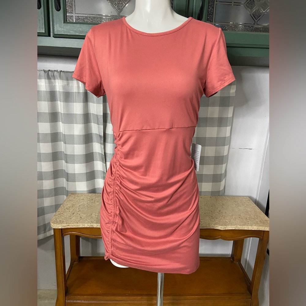 Coral dress with asymmetrical gathering